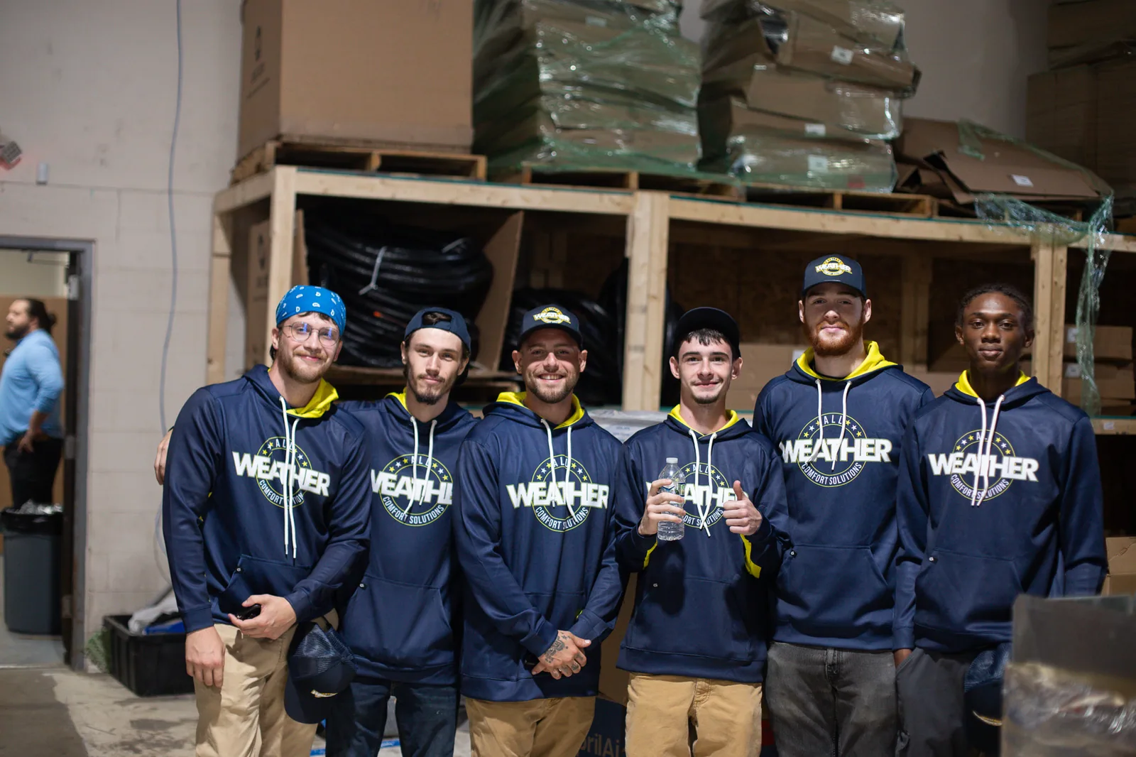 Members of the All Weather team gathered at the shop
