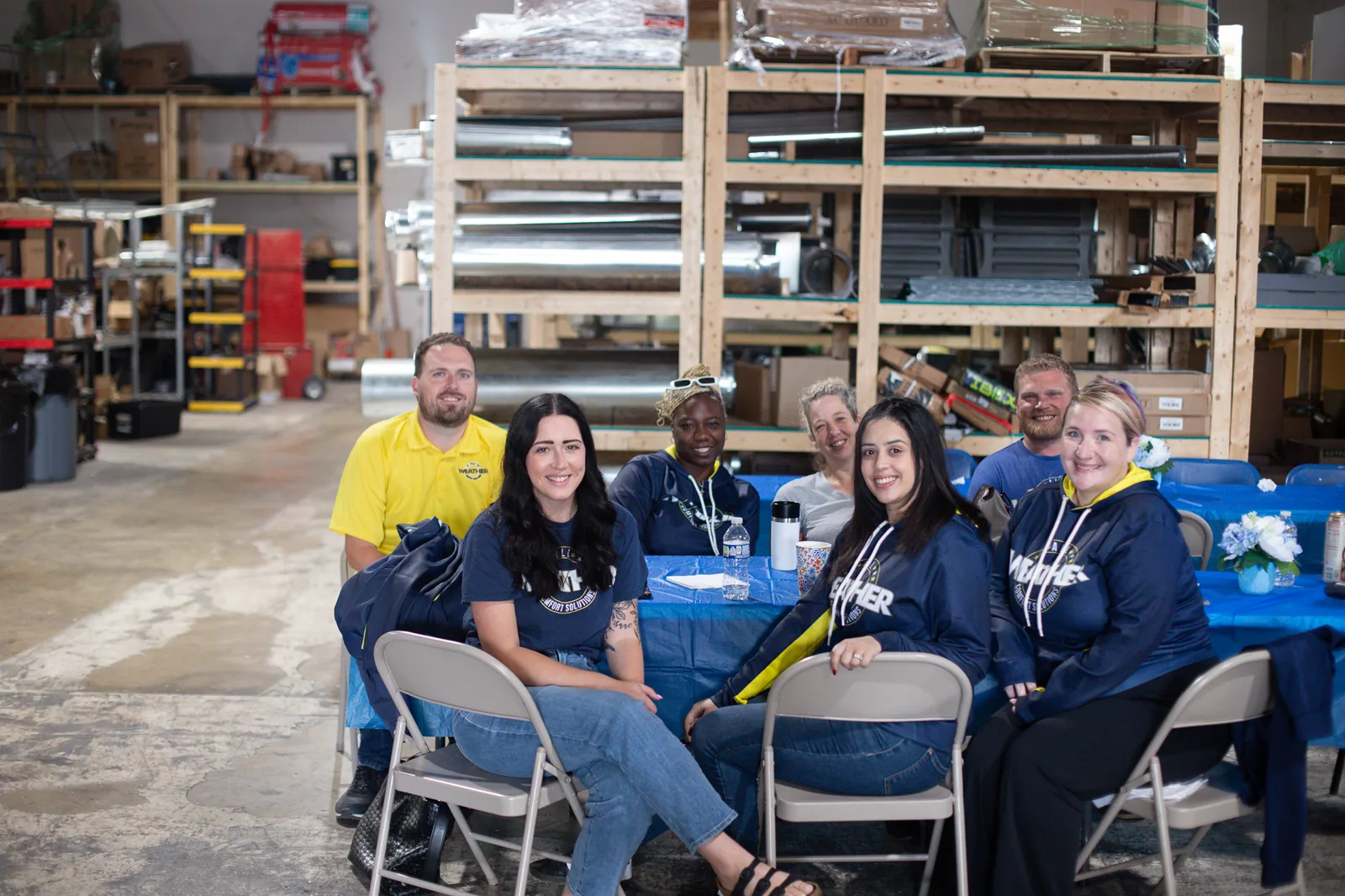 Team members gathered around a table talking